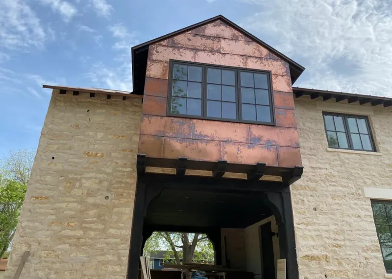 Copper metal panel facade on a stone building for Roof Repair in Cedartown